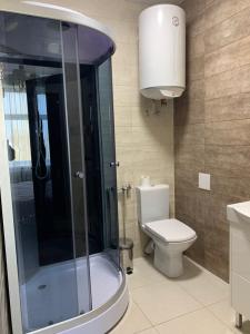 a bathroom with a toilet and a glass shower at готель ПРИБЕРЕЖНИЙ in Pavlohrad