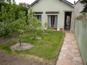 a yard with two trees in front of a house at le clermontain in Les Clérimois