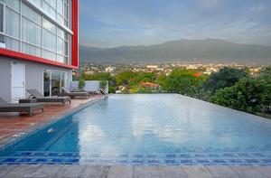 a swimming pool on the side of a building at Hotel Santika Palu in Palu