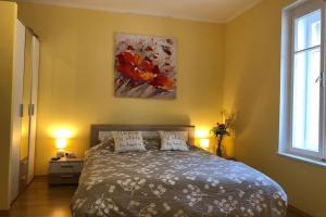 a bedroom with a bed and a painting on the wall at Zadar Old City Apartment Leonardo in Zadar