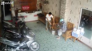 two people standing in a room with a motorcycle at Nhà nghỉ Hòa Yến 1 in Yên Bái