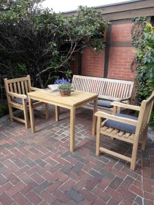 a wooden table and two chairs and a table and benches at Charmante, moderne Wohnung in Greven