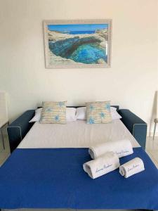 ガリポリにあるAppartamento vista mare doccia saunaidromassaggioのベッドルーム1室(青いシーツと枕のベッド1台付)