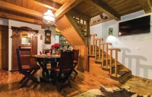 uma sala de jantar com uma mesa e uma escada em Green Paradise em Donje Gredice