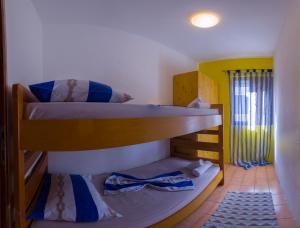 a bunk bed room with two bunk beds at The Sea House Apartments in Vis