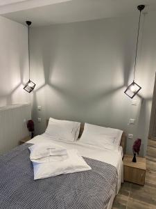 a bedroom with a bed with two white towels on it at Overwave Apartment in Kavála