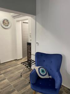 a blue chair with an eyeball on it in a room at Overwave Apartment in Kavála