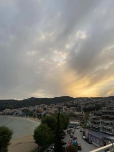 a view of a city with a beach and buildings at Overwave Apartment in Kavála