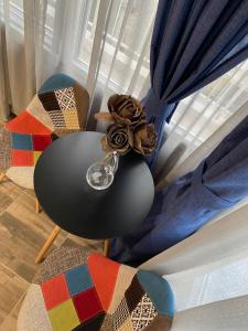a table and chairs in front of a window at Overwave Apartment in Kavála