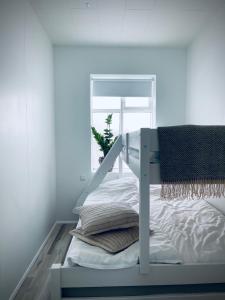 a white bunk bed in a room with a window at Day Dream Central Akureyri Two Bedroom Apartment in Akureyri