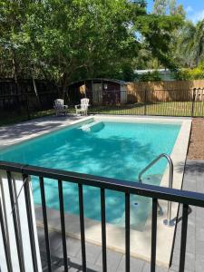 a swimming pool with a fence around it at Rainforest Retreat in Mission Beach