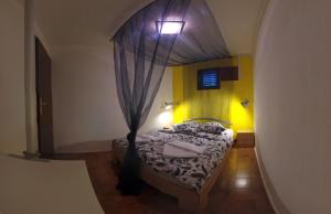 a bedroom with a bed with a canopy at The Sea House Apartments in Vis