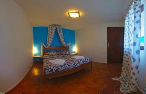 a bedroom with a bed with a canopy at The Sea House Apartments in Vis