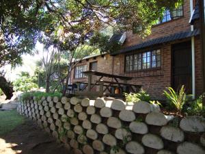 a stone fence in front of a house at Trafalgar Chalets Unit 1 in Southbroom