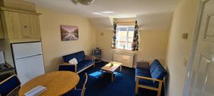 a small living room with a table and chairs at Yeats Village in Sligo