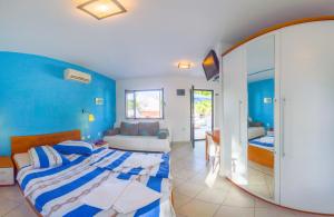 a bedroom with a large bed and a mirror at The Sea House Apartments in Vis