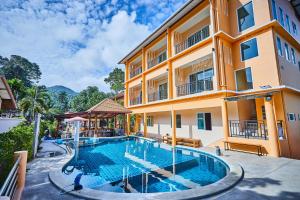 an image of a swimming pool in front of a building at Coco Palm Hotel Koh tao in Koh Tao