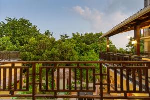 a deck of a house with trees in the background at Sea View Villa Ukulhas in Ukulhas