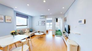 a living room with a couch and a table at HongKong Tower managed by Lily Home in Hanoi