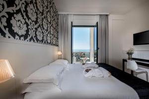 Cama ou camas em um quarto em Hotel Villa Rosa Riviera