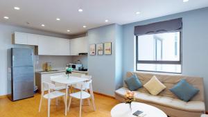 a living room with a couch and a table at HongKong Tower managed by Lily Home in Hanoi