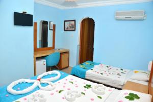 a hotel room with two beds and a mirror at Side Temple Hotel in Side