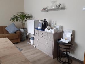 a room with a white dresser and a refrigerator at Nähe Nürburgring in Quiddelbach, Gästezimmer mit Lounge in Quiddelbach