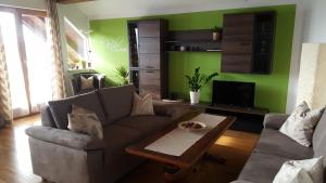 a living room with a couch and a coffee table at Apartment Elisabeth Stadler in Sankt Gilgen