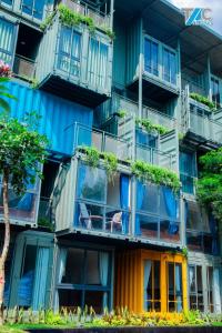 an apartment building with colorful balconies and plants at Amacon Hotel & Coffee in Buôn Kô Sir
