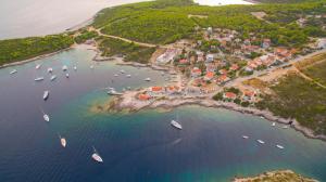 an aerial view of a small island with boats in the water at The Sea House Apartments in Vis