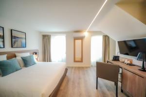 Telewizja i/lub zestaw kina domowego w obiekcie Bergamo Inn 15