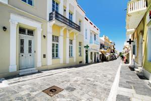 a cobblestone street in a town with buildings at Castel Abaso Boutique Apartments by Explore Andros in Andros