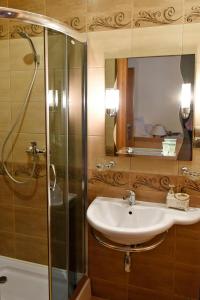 een badkamer met een wastafel en een douche bij Apartament City, Clock in Krosno