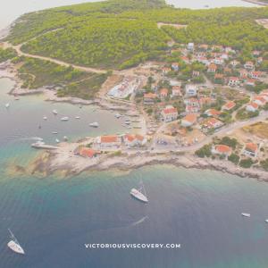 an aerial view of a beach with boats in the water at The Sea House Apartments in Vis