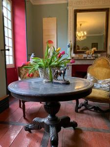 a table with a potted plant on it in a room at Chateau Mas de Pradie B&B Fountain view room in Foissac