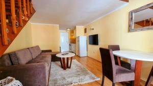 a living room with a couch and a table at Becici Apart Budva in Budva