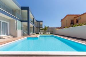 a swimming pool in the backyard of a house at Residence Meridian Unità 6 in Villa San Pietro