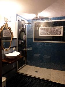 a bathroom with a shower with a sink and a toilet at Baia D'Oro in Sabaudia