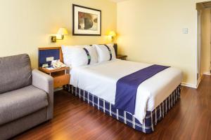 a hotel room with a bed and a couch at Holiday Inn Lisbon by IHG in Lisbon