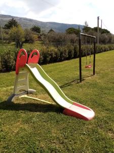 a slide in a park with a playground at Podere Battegone in Menestrello