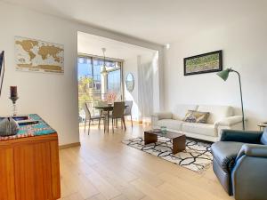 a living room with a couch and a table at Nestor&Jeeves - TOUCAN DUPLEX TERRACE - Hyper center - Top floor in Nice