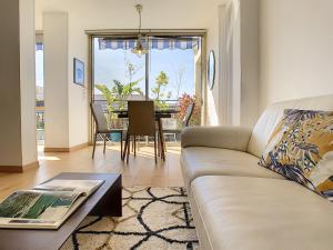 a living room with a couch and a table at Nestor&Jeeves - TOUCAN DUPLEX TERRACE - Hyper center - Top floor in Nice