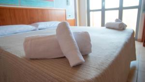 two towels on a bed in a hotel room at Hotel Royal in Giulianova