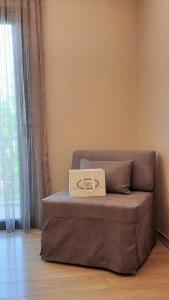 a box on top of a couch in a room at Olympic Fashion Hotels in Athens