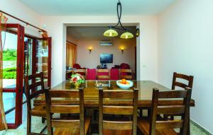 a dining room and living room with a table and chairs at Villa Anka in Zaton
