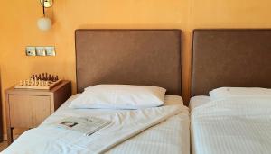 two beds sitting next to each other in a bedroom at Olympic Fashion Hotels in Athens