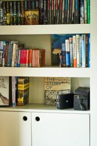 a book shelf with books on it at An Airigh in Cairndow