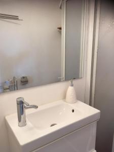 a bathroom with a white sink and a mirror at Sälens By in Sälen