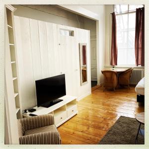 a living room with a flat screen tv on a wall at Cleen Rochelle in Middelburg