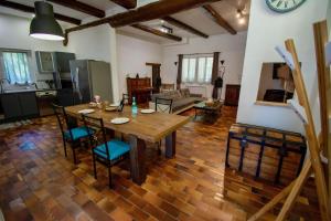 cocina y sala de estar con mesa de madera y sillas en La Maison du Moulin de Tartay, en Aviñón